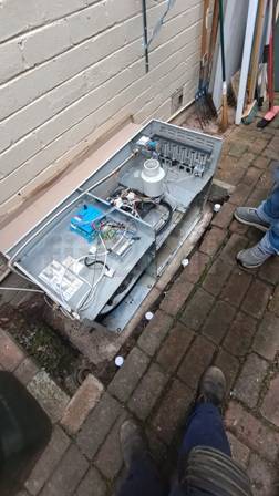 Gas ducted heating service: A Bonaire external ducted heater being opened to inspect parts on jobsite