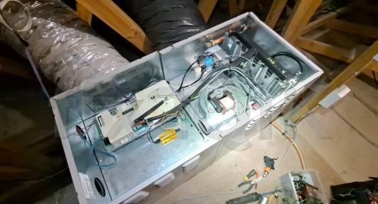 ducted-heating-service-an-internal-brivis-heater-opened-shows-flame-burner-parts-electronic-pcb-fan-motor-gas-valve-pressure-switch-during-a-maintenance